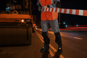 man-special-clothes-blocks-road-with-tape-street-asphalt-resurfacing-concept-300x200